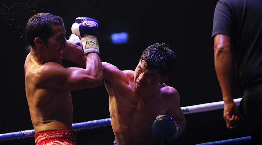 A picture of boxers fighting, but why do boxers wear gloves?